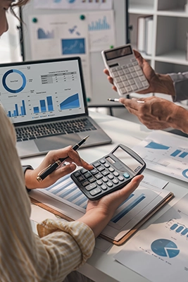Two business people talk project strategy at office meeting room. Businessman discuss project planning with colleague at modern workplace while having conversation and advice on financial data report.