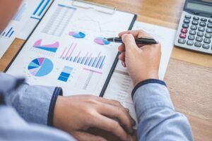 Business Financing Accounting Banking Concept, businessman doing finances and calculate about cost to real estate investment and in other, tax system.